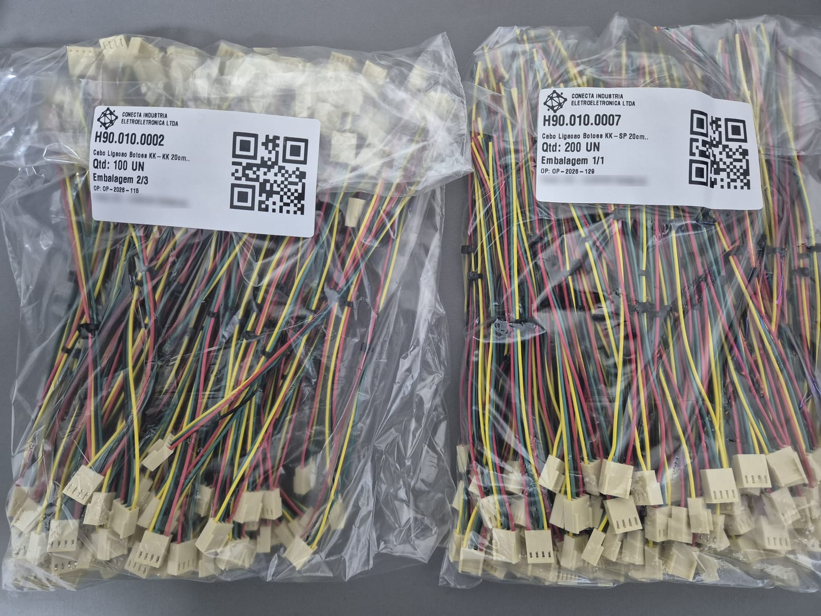 Chicotes elétricos embalados e etiquetados com código do item, quantidade e ordem de produção